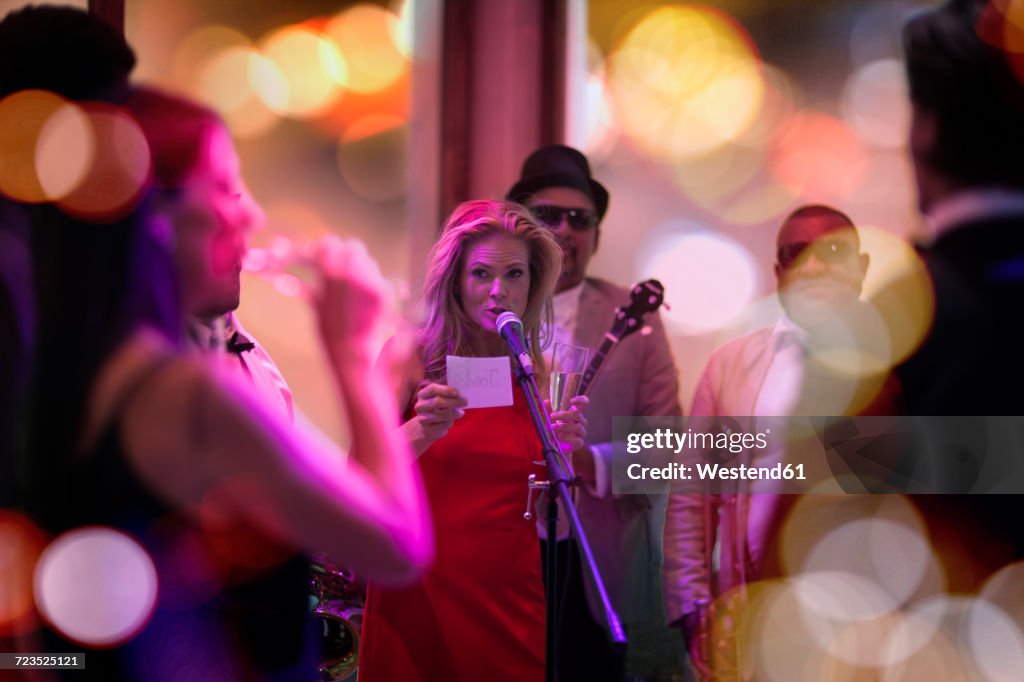 People celebrating and having fun on a party, woman making an announcement