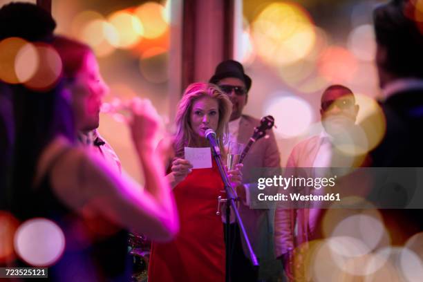 people celebrating and having fun on a party, woman making an announcement - fabolous musician stockfoto's en -beelden
