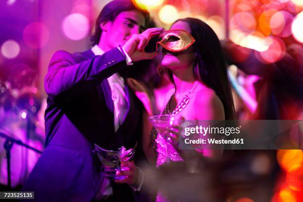 couple celebrating and having fun on a costume party - abendgarderobe stock-fotos und bilder