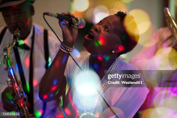 band playing with woman singing - singer stock pictures, royalty-free photos & images