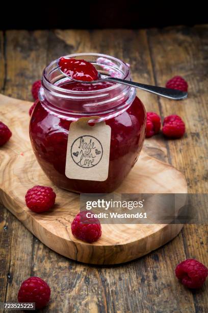 spoon and jar of raspberry jam and raspberries on wood - jam jar stock pictures, royalty-free photos & images