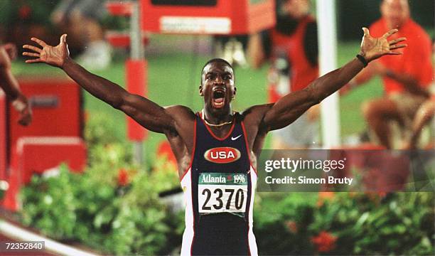 Michael Johnson of the USA celebrates after his winning the men's 200 meters in a new world record time of 19.32 seconds in the Centennial Olympic...