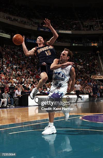 Forward Chris Andersen of the Denver Nuggets collides with point guard John Crotty of the Utah Jazz during the NBA game at the Delta Center in Salt...