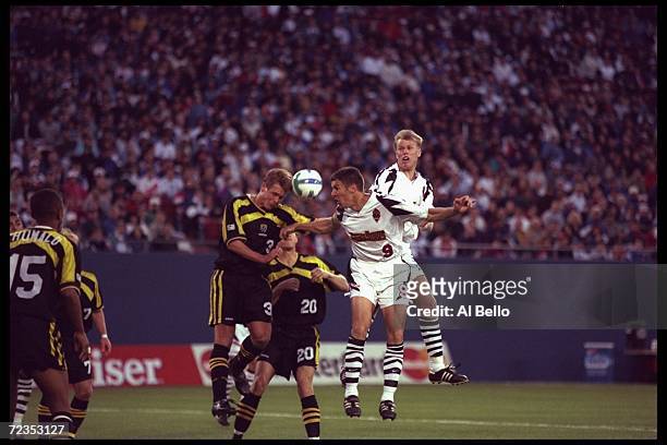 Peter Vermes of the New York/New Jersey Metrostars fights Columbus Crew players Michael Clark and Brian McBride for the ball during an MLS game...