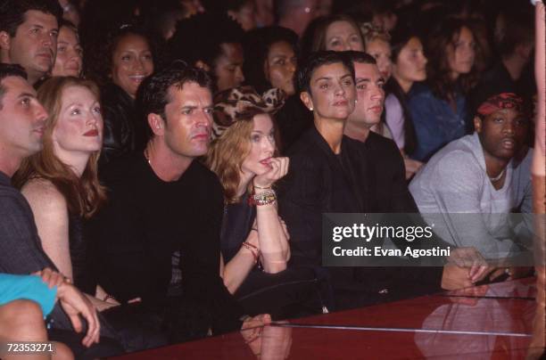 From left to right, Julianne Moore, Rupert Everett, Madonna and Ingrid Casares attend the Versace Versus fashion show September 12, 1999 in New York...