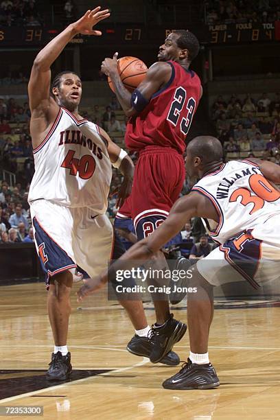 Michael Jordan of the Pennsylvania Quakers protects the ball as Illinois Fighting Illini''s Sergio McClain and Frank Williams defend during their...