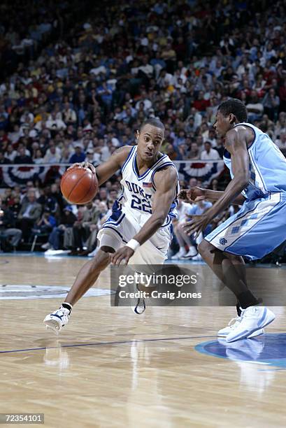 Jason WIlliams of Duke drives to the basket against Jackie Manuel of North Carolina during the ACC Tournament game at the Charlotte Coliseum in...