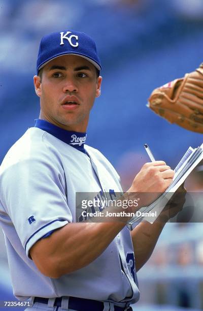 Carlos Beltran of the Kansas Royals signs a fans program before the game against the Chicago White Sox at Comiskey Park in Chicago, Illinois. The...