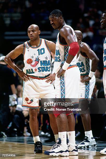 Hakeem Olajuwon and Charles Barkley of the Western Conference All Stars look on during the 1996 NBA All Star Game played on February 11, 1996 at the...