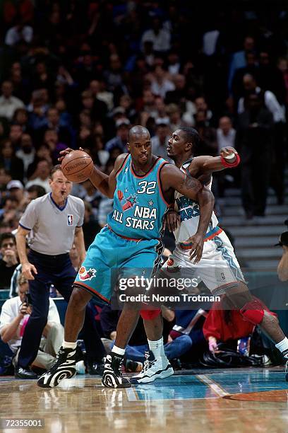 Shaquille O'Neal of the Eastern Conference All Stars posts up against Hakeem Olajuwon of the Western Conference All Stars during the 1996 NBA All...