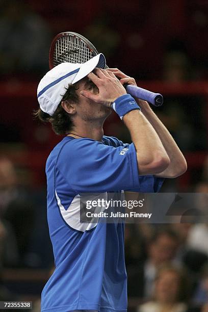 Andy Murray of Great Britain puts his hands to his face after losing the first set against Dominik Hrbaty of Slovakia in the third round during day...