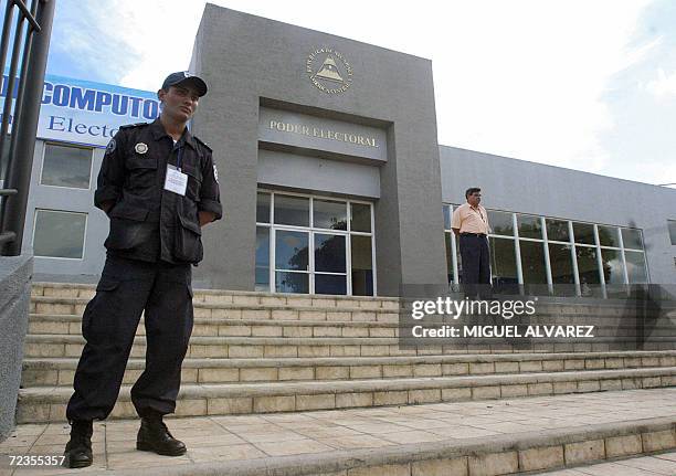 Policeman of a special unit keeps guard at the main entrance of the Supreme Electoral Council, where the computer center is installed, in Managua,...