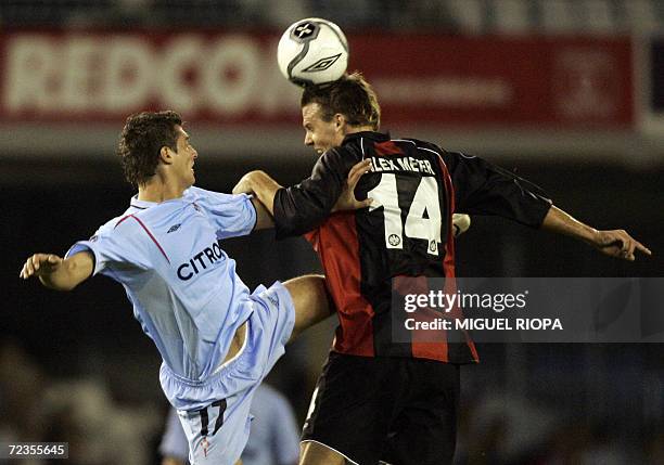 Celta Vigo's Romanian Gabriel Tamas heads the ball with Eintracht's Alexander Meier during a UEFA Cup group H football match at the Balaidos Stadium...