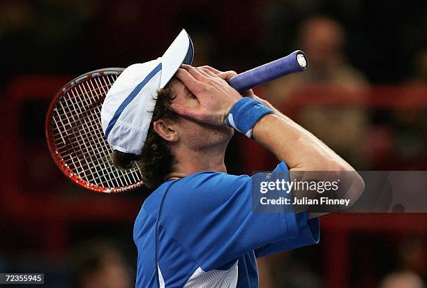 Andy Murray of Great Britain puts his hands to his face after losing the first set against Dominik Hrbaty of Slovakia in the third round during day...