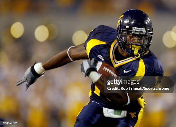 Running Back Steve Slaton of West Virginia Mountaineers rushes against the Maryland Terrapins at Milan Puskar Stadium, the home of Mountaineer Field,...