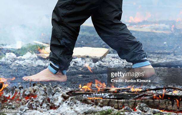 Man walks over fire with bare feet during Walking-over-Fire festival at the downskirt of Mt.Takao on March 13, 2005 in Hachioji, Japan. This is an...
