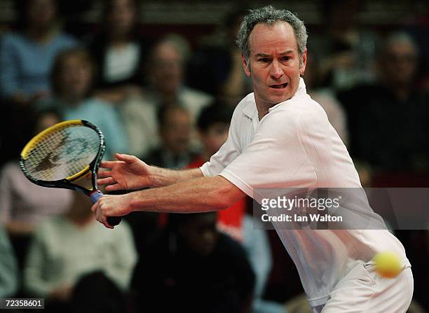 John McEnroe of USA returns the ball to Mikael Pernfors of Sweden during The Masters Tennis tournament at the Royal Albert Hall on December 3, 2004...