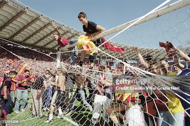 Roma fans celebrate the Scudetto by invading the pitch after a 3-1 victory in the Serie A match against Parma at the Stadio Olimpico in Rome....