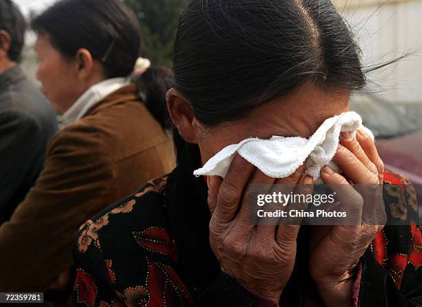 Families of victims poisoned dead by a liquefied chlorine leak cry at a crematory in a village on April 2, 2005 in Huaian of Jiangsu Province, China....