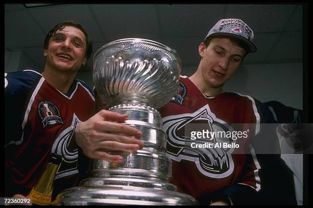 Colorado Avalanche leftwinger Valeri Kamensky and defenseman Sandis Ozolinsh pose with the Stanley Cup after defeating the Florida Panthers in Game...