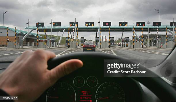 Vehicle approach the M6 motorway toll booths on March 13, 2005 in Birmingham, England. The number of vehicles using the Toll road which opened in...