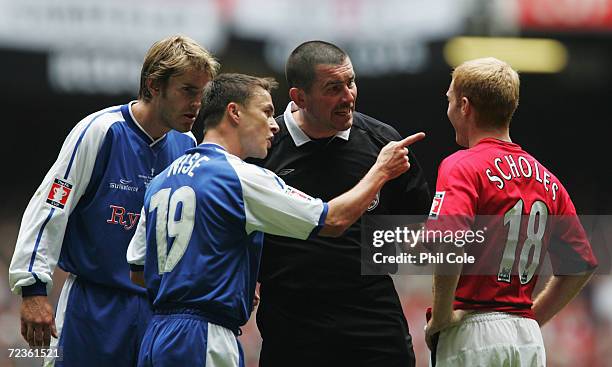 Referee Jeff Winter and Dennis Wise of Millwall talk to Paul Scholes of Manchester United during the 123rd FA Cup Final between Manchester United and...