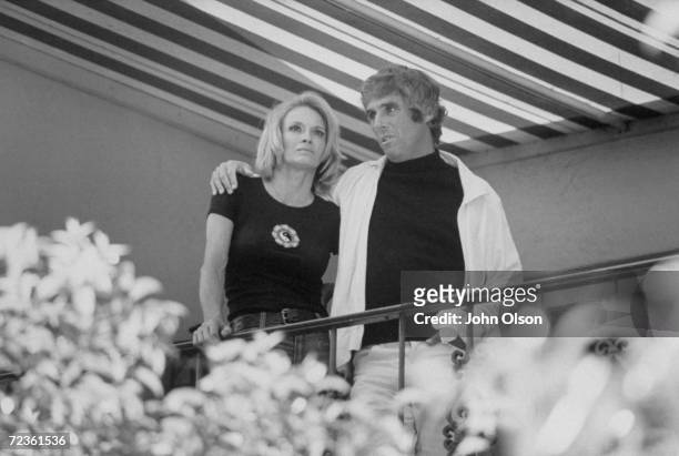 Composer Burt Bacharach Jr. Standing with his arm around his actress wife Angie Dickinson.