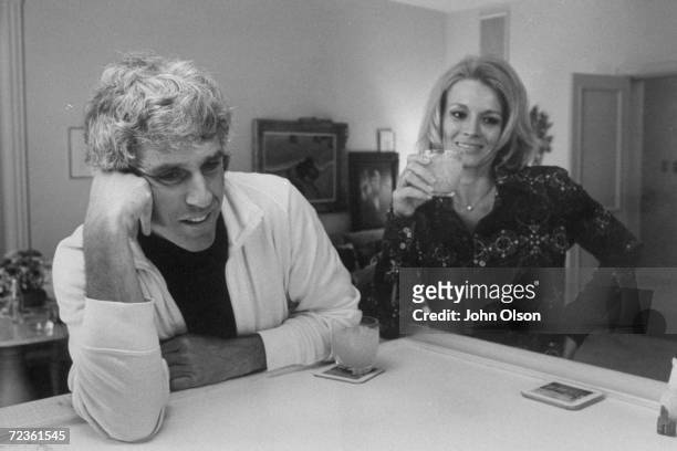 Composer Burt Bacharach Jr. And his actress wife Angie Dickinson having a drink together at their Beverly Hills home.