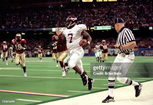 Michael Vick of the Virginia Tech Hokies runs with the ball during the Nokita Sugar Bowl Game against the Florida State Seminoles at the Louisiana...