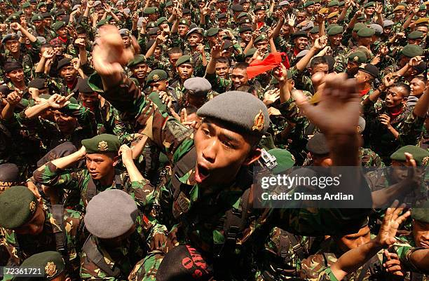 Thousands of soldiers from the Indonesian Army's Strategic Command cheer and dance during the elite unit's 46th anniversary March 6, 2003 in Jakarta,...