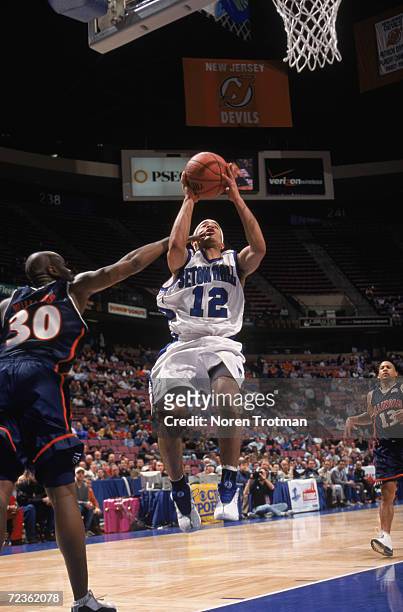 Guard Andre Barrett of the Seton Hall Pirates shoots the ball as guard Frank Williams of the Illinois Fighting Fighting attempts to block during the...