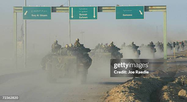 Marine armored attack vehicle from Task Force Tarawapass a highway sign April 3, 2003 in central Iraq. The Marines continue to sweep through the...