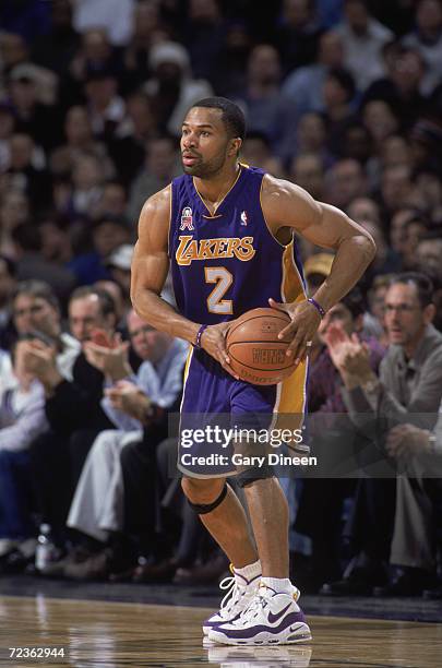 Point guard Derek Fisher of the Los Angeles Lakers holds the ball during the NBA game against the Milwaukee Bucks at the Bradley Center in Milwaukee,...