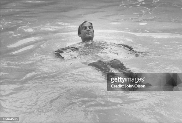 Ford Motor Co. President Lee A. Iacocca, swimming in his private pool.