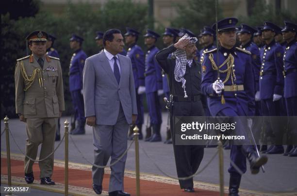 Egyptian President Hosni Mubarak reviewing honor guard with PLO leader Yasser Arafat.