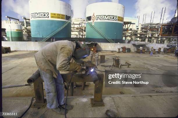 Welder at work at Pemex oil refinery.