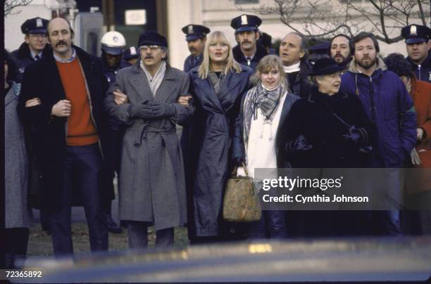 Paul Stookey , Peter Yarrow and Mary Travers of folk group "Peter, Paul and Mary" and others, marching during anti-apartheid demo.