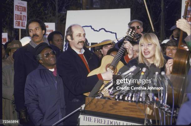 South African Bishop Desmond Tutu at anti apartheid rally with Transafrica's Randall Robinson , Pat Schroeder , and folk group Peter, Paul and Mary -...