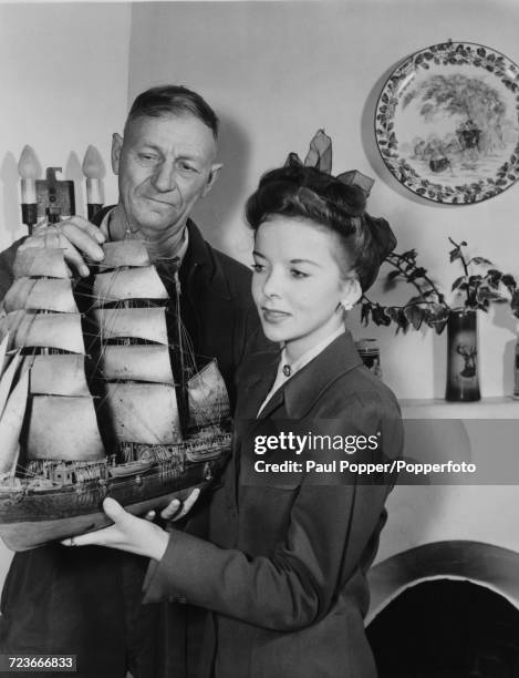 English born American actress Ida Lupino is presented with a ship's model by Louis Madsen in Hollywood, Los Angeles during the making of the film...