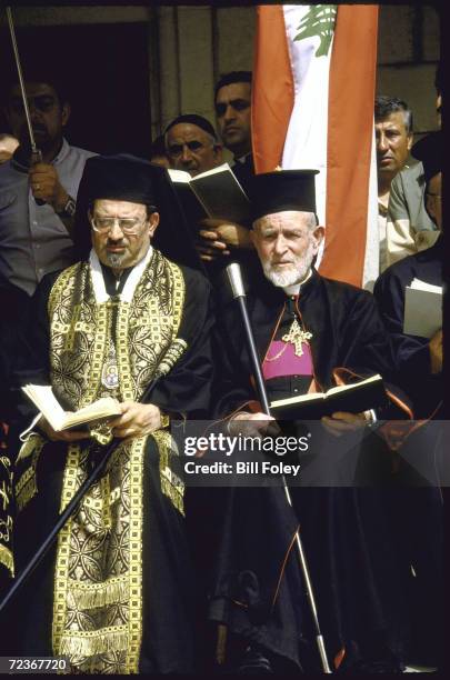 Maronite Christian clergymen officiating during mass funeral for victims of car bombing, at church in Christian East Beirut.