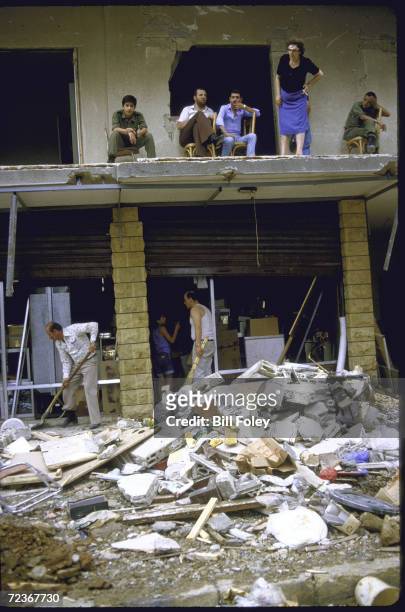 Christian Lebanese forces militiamen and locals view damage wrought by terrorist car bombing killing over 30 people in Sin El Fil, East Beirut, May,...
