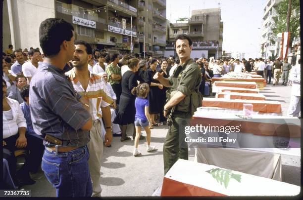 Christian Lebanese militiamen providing security during mass funeral for victims of car bombing.