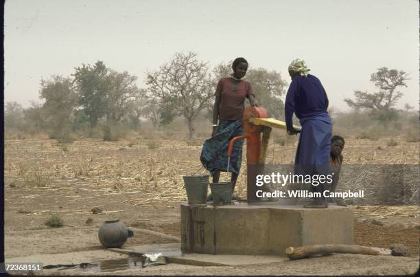 Villagers gathering water at local well.