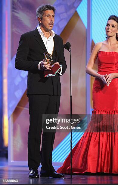 Cachorro Lopez accepts his award for "Producer Of The Year" from presenter Barbara Palacios on stage at the 7th Annual Latin Grammy Awards at Madison...