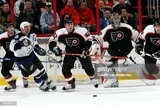Triston Grant and Antero Niittymaki of the Philadelphia Flyers clears the puck out of the crease against Tim Taylor of the Tampa Bay Lightning at the...