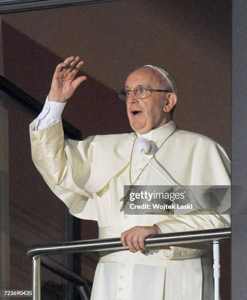 Pope Francis greets the crowd from the window above the entrance to the Bishop's Palace at 3 Franciszkanska Street in Krakow, Poland, on June 27th,...