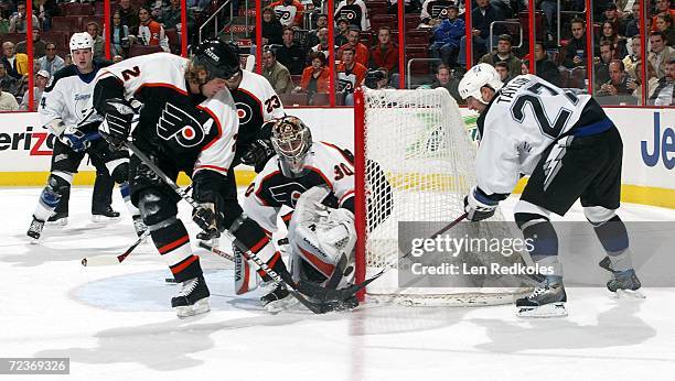 Tim Taylor of the Tampa Bay Lightning slaps the puck past Antero Niittymaki and Derian Hatcher of the Philadelphia Flyers at the Wachovia Center on...