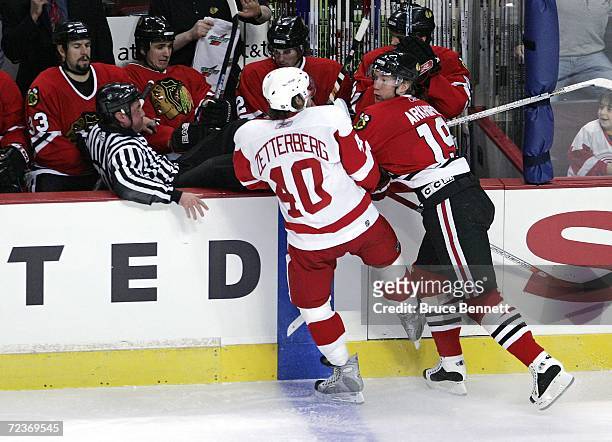 Linesman Pat Dapuzzo ends up in the bench as the result of a hit by Denis Arkhipov of the Chicago Black Hawks on Henrik Zetternerg of the Detroit Red...