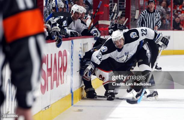 Simon Gagne of the Philadelphia Flyers is checked off the puck by Dan Boyle of the Tampa Bay Lightning at the Wachovia Center on November 2, 2006 in...