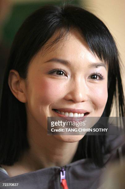 Singaporian actress Fann Wong looks at a Cambodian blind students learning computing during a visits the blind school of Krousar Thmey organization...